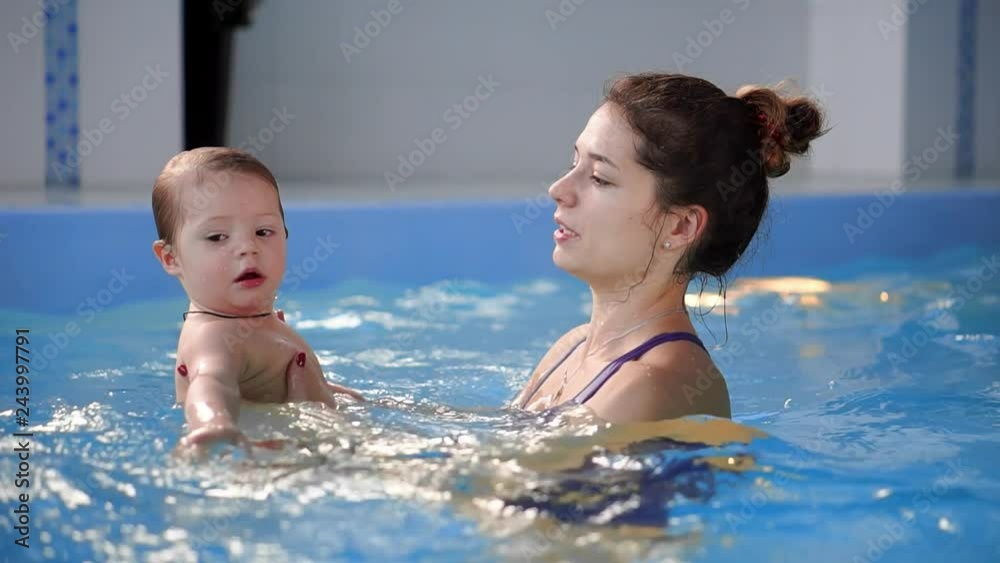 Cute baby boy enjoying with his mother in the pool. Cute baby boy enjoying with his mother in the pool.