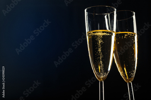 Fotótapéta Champagne glasses for festive occasion against a dark background