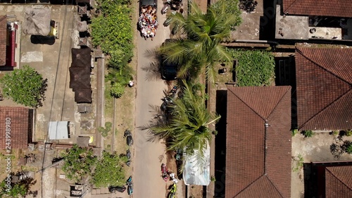 4K aerial flying video of balinese houses during the big celebration. Bali ceremony in village, Ubud. Roofs of balinese houses.
