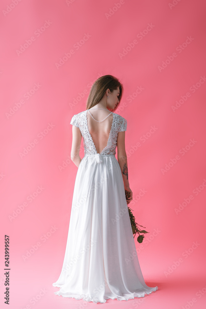 Beautiful young bride in boudoir dress on canvas background with paint. Wedding trends and ideas 2019, spring inspiration.