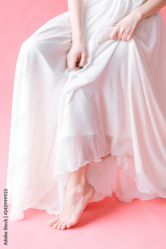 Beautiful young bride in boudoir dress on canvas background with paint. Wedding trends and ideas 2019, spring inspiration. Beautiful young bride in boudoir dress on canvas background with paint. Wedding trends and ideas 2019, spring inspiration.