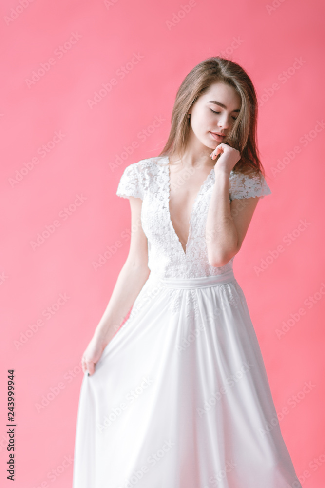 Beautiful young bride in boudoir dress on canvas background with paint. Wedding trends and ideas 2019, spring inspiration.