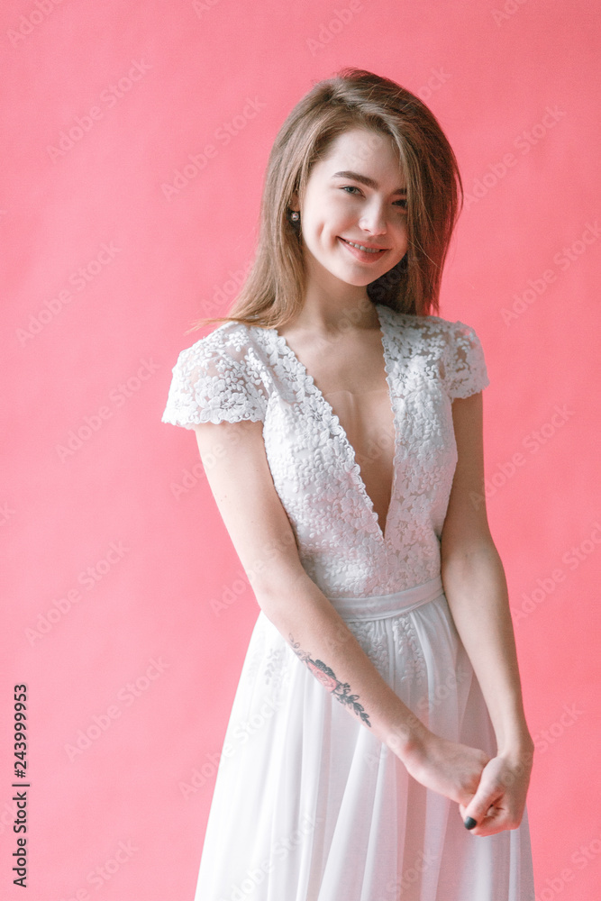 Beautiful young bride in boudoir dress on canvas background with paint. Wedding trends and ideas 2019, spring inspiration. Beautiful young bride in boudoir dress on canvas background with paint. Wedding trends and ideas 2019, spring inspiration.