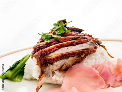 Roast Duck Rice. Popular Chinese barbecue rice dish of rice with slices of roast duck, thick sauce, and choy sum. photo