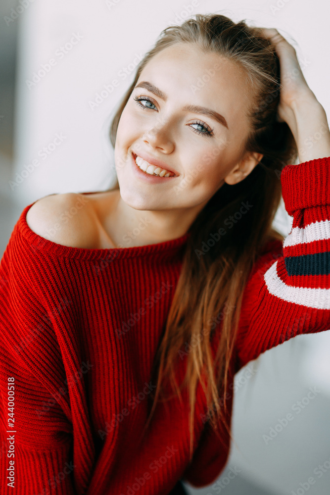 Beautiful Russian girl in a red jacket. Emotional portraits with a cute  face. Stock Photo