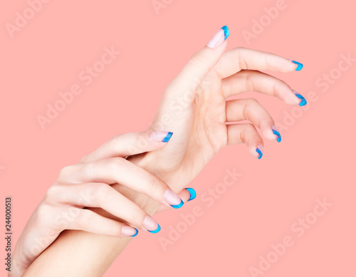 Female hands with woman s professional french nails manicure isolated on pantone 16-1546 living coral clolor