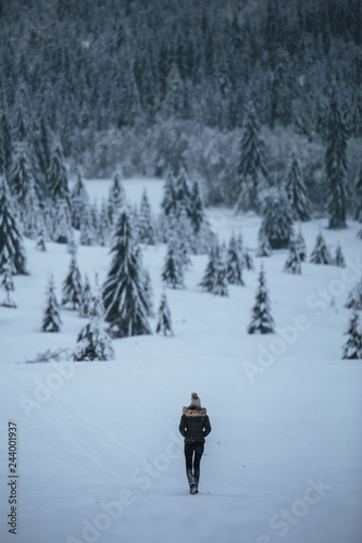 Young traveler people walking in the snowy forest