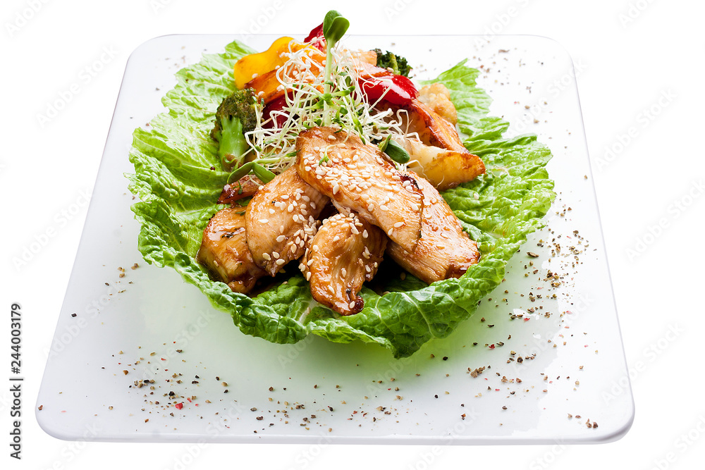 Chicken fillet with vegetables in soy-garlic sauce. On white background Chicken fillet with vegetables in soy-garlic sauce. On white background