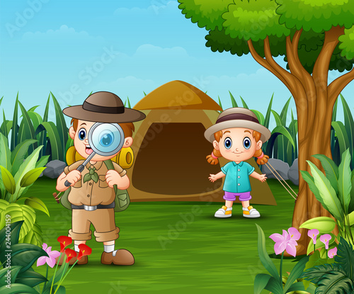 Boy explorer and a girl camping out in the beautiful park