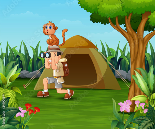 Zookeeper boy and his monkey camping in the beautiful park