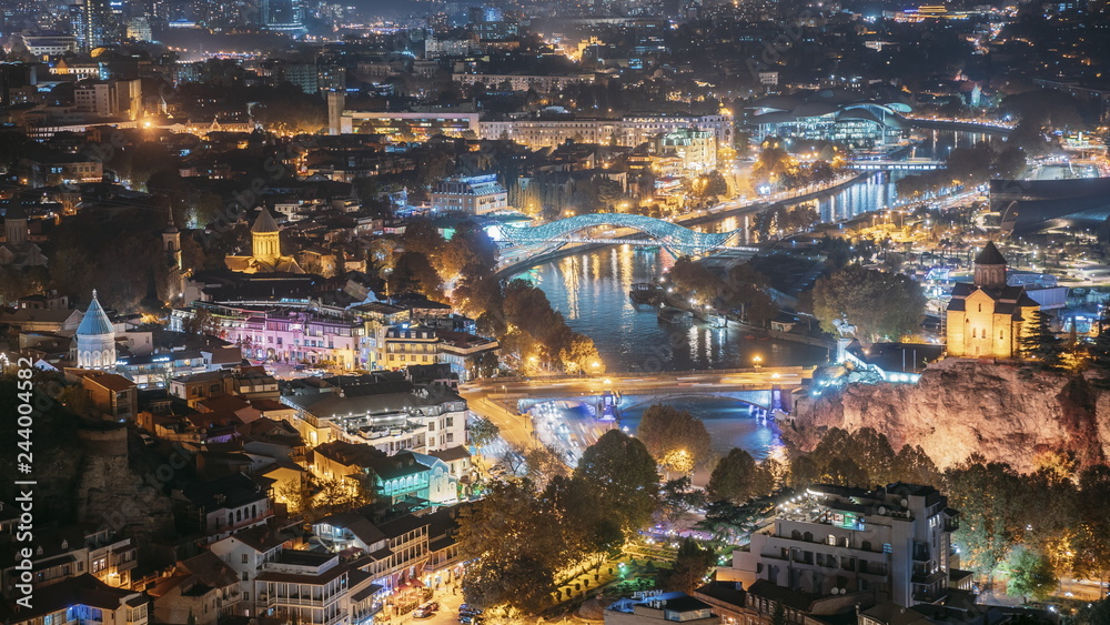 Tbilisi, Georgia. Top View Of Famous Landmarks In Evening Or Night Illuminations. Georgian Capital Skyline Cityscape