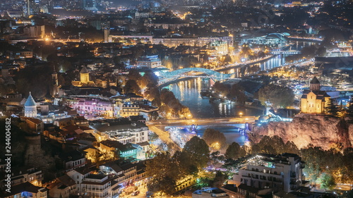 Tbilisi, Georgia. Top View Of Famous Landmarks In Evening Or Night Illuminations. Georgian Capital Skyline Cityscape © Grigory Bruev