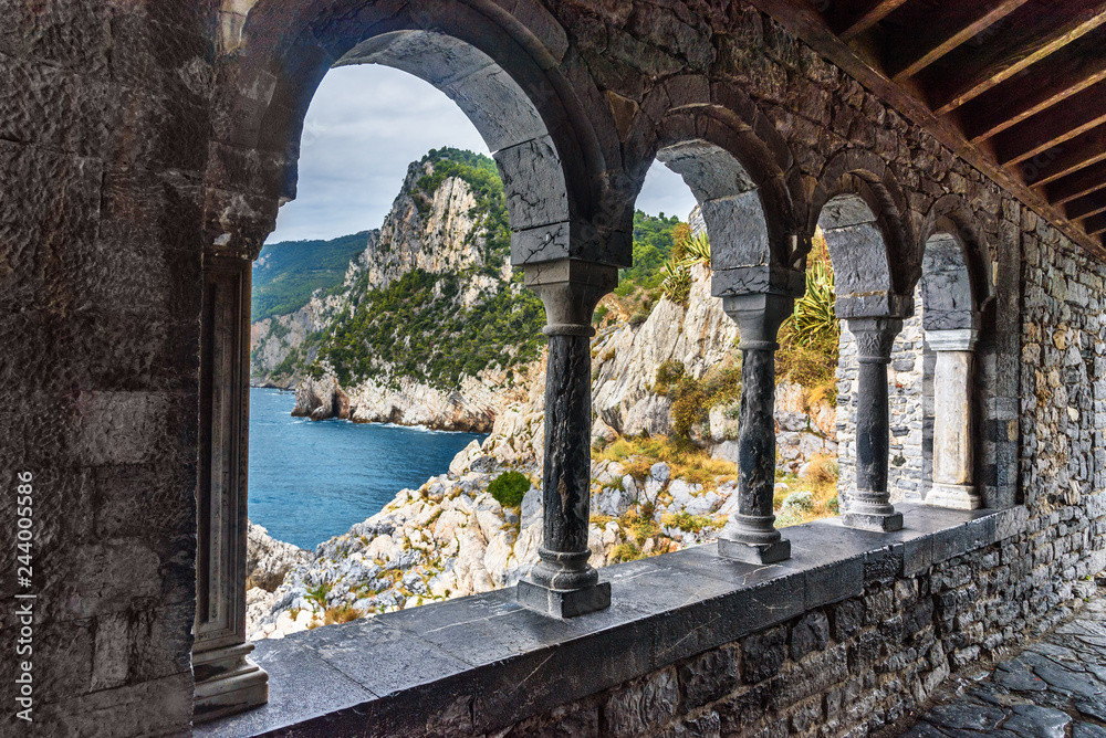 View through columns of Church of St. Peter in Portovenere or Porto Venere town on Ligurian coast. Italy