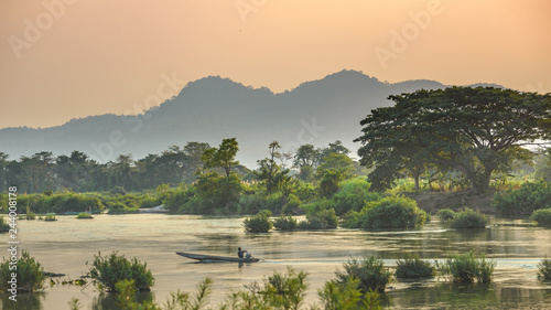 Mekong River 4000 islands Laos, sunrise dramatic sky, mist fog on water, famous travel destination backpacker in South East Asia photo