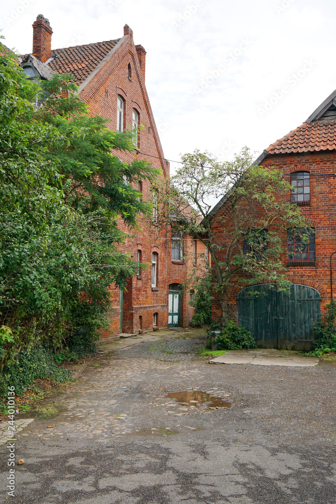 old homestead or farmstead with red brick buildings                             