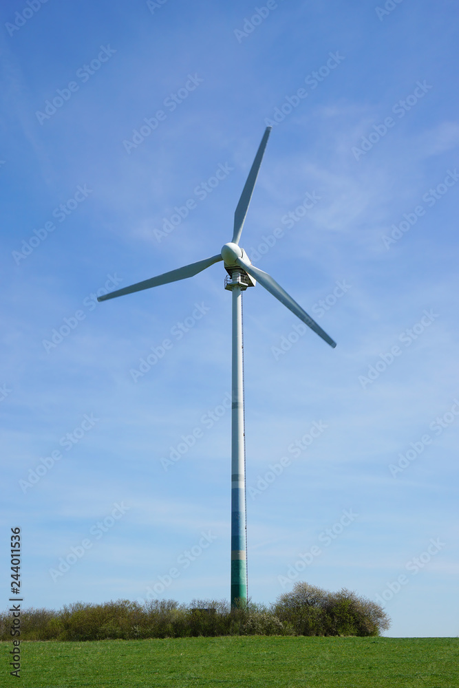 solitary three-bladed wind turbine in a meadow solitary three-bladed wind turbine in a meadow
