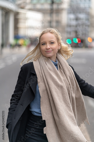 Happy and cheerful businesswoman with blonde hair in the city of London