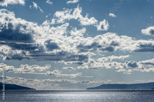 Landscape view of dark sky and sea before the storm. Blue cast. photo