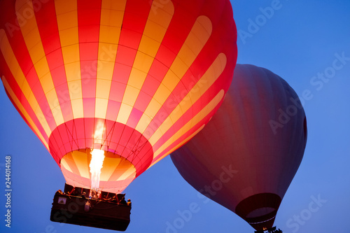 Beautiful hot air balloons flying over Cappadocia landscape at sunrise