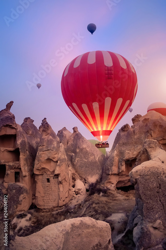 Beautiful hot air balloons flying over Cappadocia landscape at sunrise