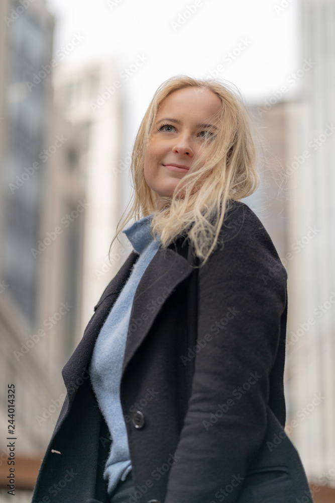 Happy and cheerful businesswoman with blonde hair in the city of London