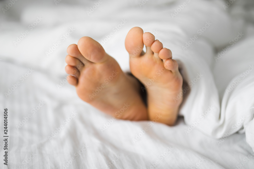 Male foots in a bed Male foots in a bed