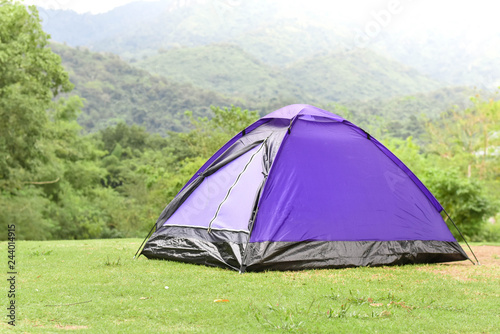 Purple color dome tent in mountain range landscapes.