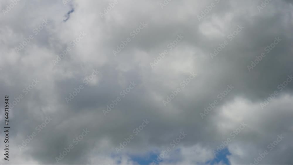 wet gray clouds draw in this timelapse over a blue sky in summer wet gray clouds draw in this timelapse over a blue sky in summer