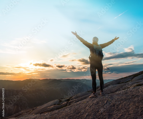 Woman successful hiking silhouette in mountains, motivation and inspiration in beautiful sunset. Female hiker with arms up outstretched on mountain top, inspirational landscape © Kotangens