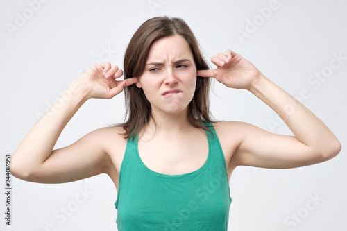 woman plugging ears pretending not to hear what she is told