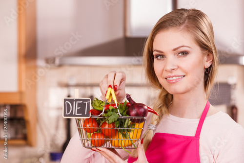Woman holding shopping backet with vegetables