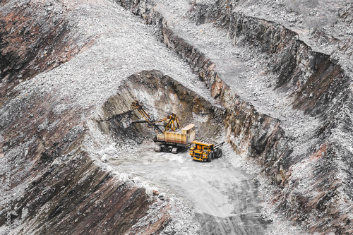 Tableau sur toile Large orange mining truck and excavator in a quarry