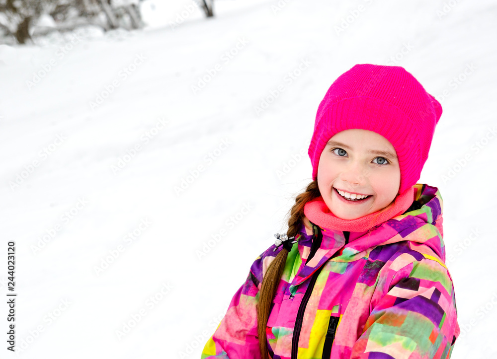 Portrait of cut smiling little girl child in winter day