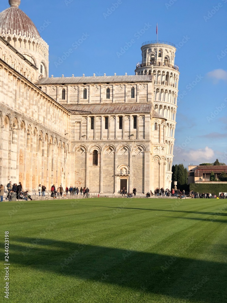 Leaning tower of Pisa, Tuscany, Italy on a sunny day full of tourists. Vertical 