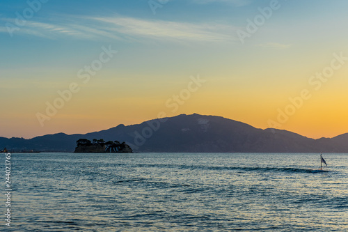 Greece  Zakynthos  Orange morning sunrise sky over impressive mountains and cameo island