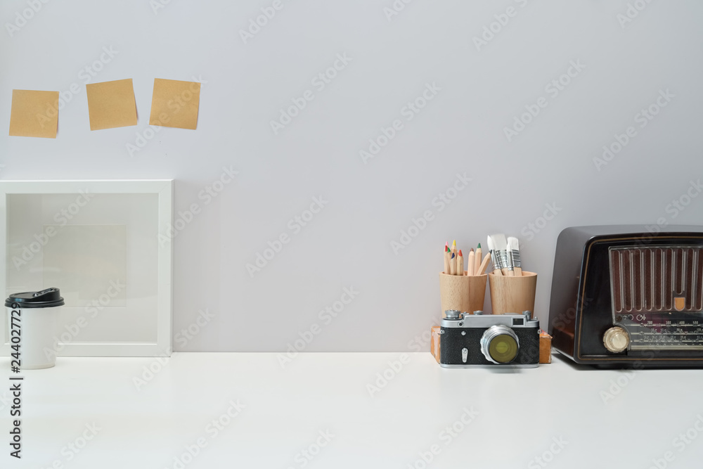 Fototapeta premium Mockup Blank poster, books, vintage radio and vintage camera on workspace desk