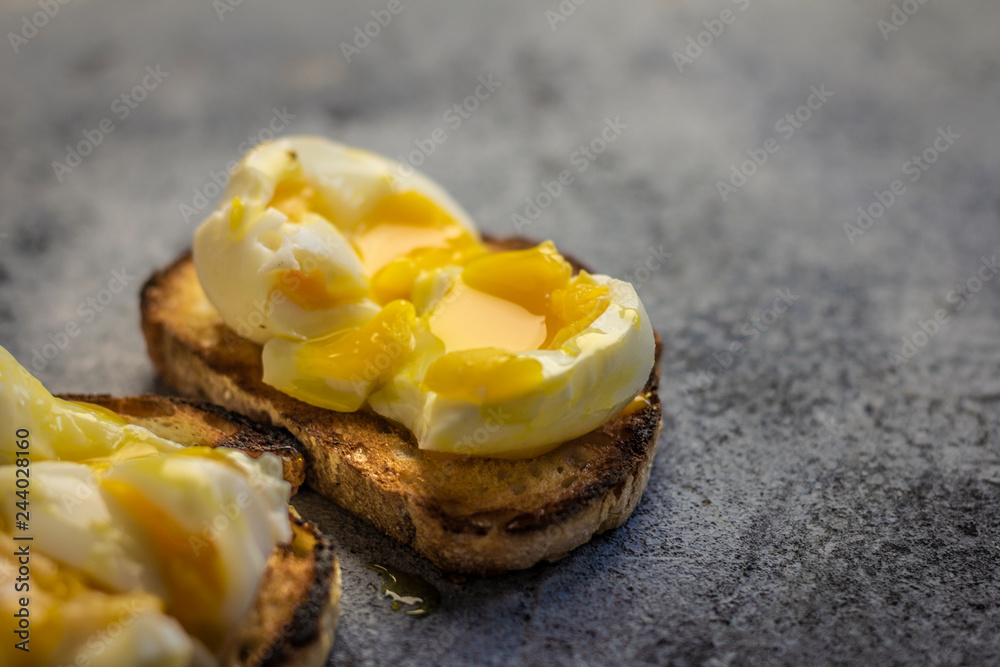 Crispy baguette toasts soft boiled egg and light blue rustic background. Crispy baguette toasts soft boiled egg and light blue rustic background.