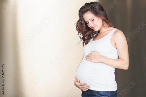 Pregnant young woman in white t shirt on bright background Free Download Pregnant young woman in white t shirt on bright background - GFXLoad