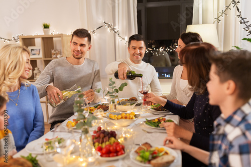 celebration, holidays and people concept - happy family having dinner party at home