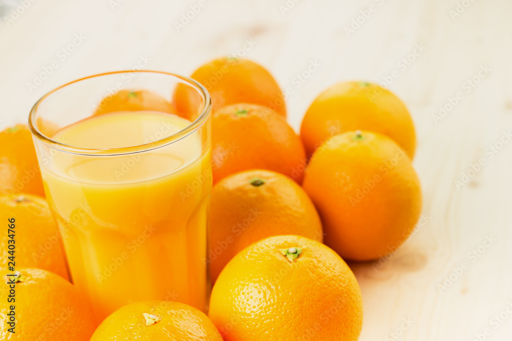 Glass of freshly pressed orange juice with oranges Glass of freshly pressed orange juice with oranges