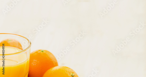 Glass of freshly pressed orange juice with oranges