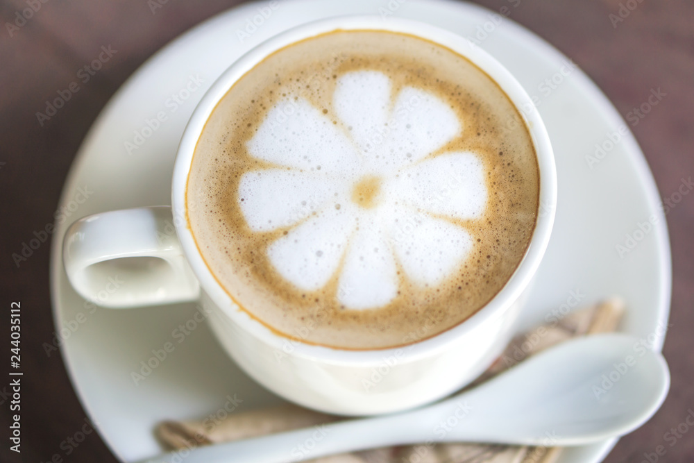 closeup cup of hot coffee latte flower art on wooden table at cafe shop closeup cup of hot coffee latte flower art on wooden table at cafe shop