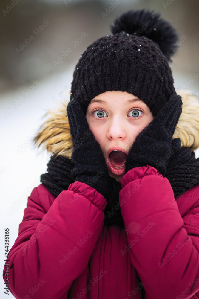 Shocked little girl, winter outdoors.
