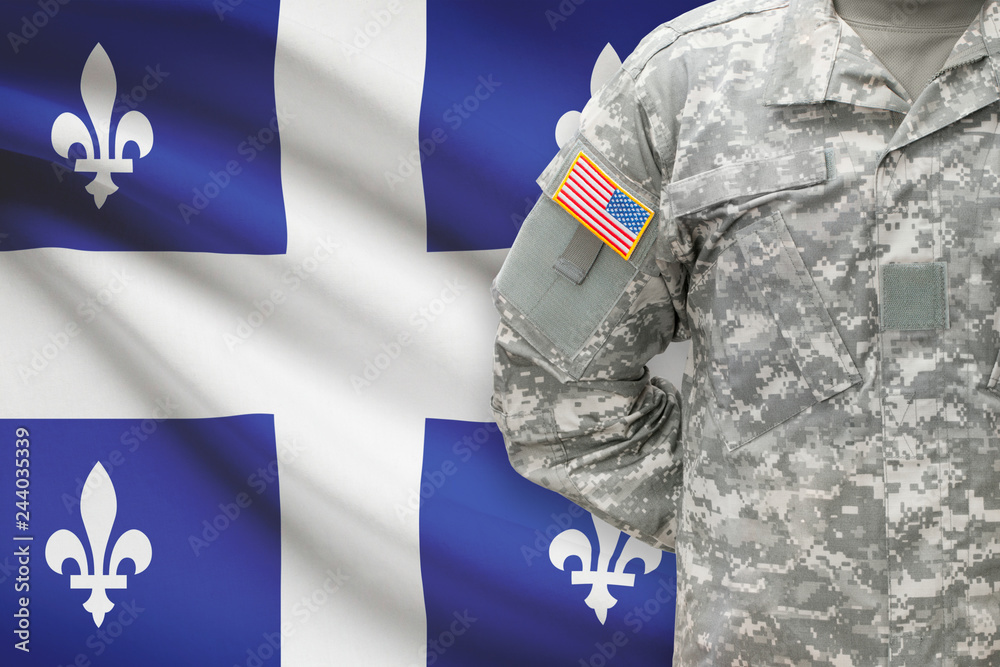 Fototapeta premium American soldier with Canadian province flag on background - Quebec