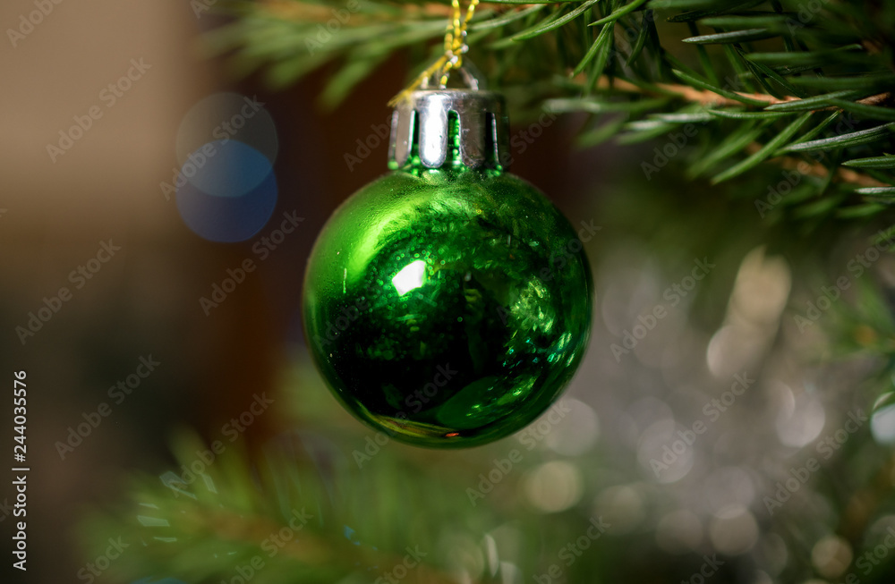 Beautiful colored glass ball on the branch of a Christmas tree Beautiful colored glass ball on the branch of a Christmas tree