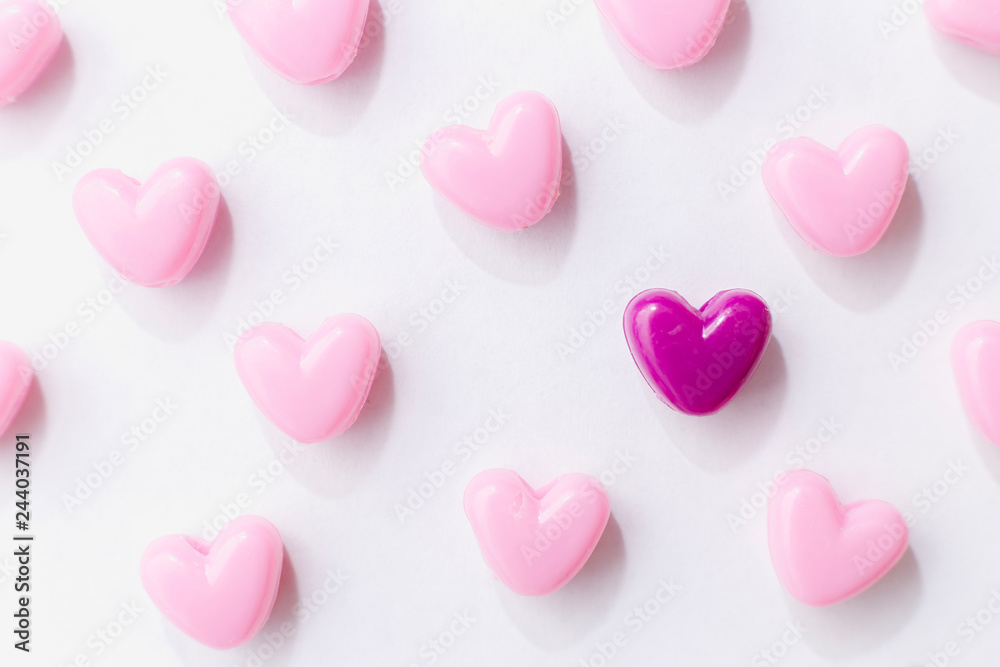 Pink beads in heart shape stacked on  table with copy space. Sweet beads for love theme on Valentine concept in vintage style.  For background or wallpaper decor. Soft Focus