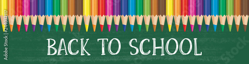 Colorful pencils on green board with text 