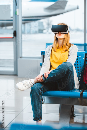 woman wearing virtual reality headset while waiting in airport