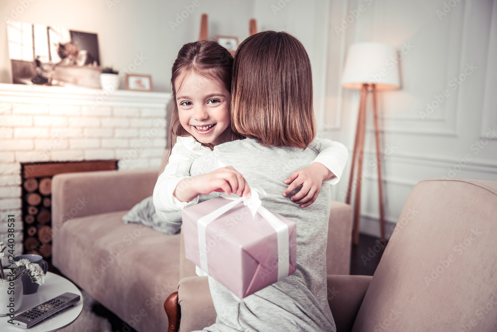 Cheerful pretty nice girl hugging her mother Cheerful pretty nice girl hugging her mother