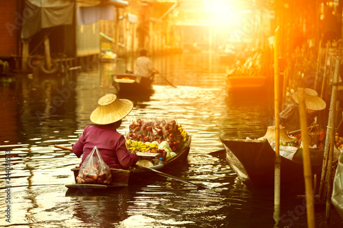 thai fruit seller sailing wooden boat in thailand tradition floating market © stockphoto mania